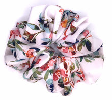 Load image into Gallery viewer, White charmeuse scrunchie with watercolor floral design on a flat surface
