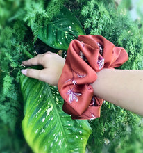 Load image into Gallery viewer, XXL satin scrunchie in burnt orange with a floral sketch design, perfect for adding a pop of color and elegance to any hairstyle.
