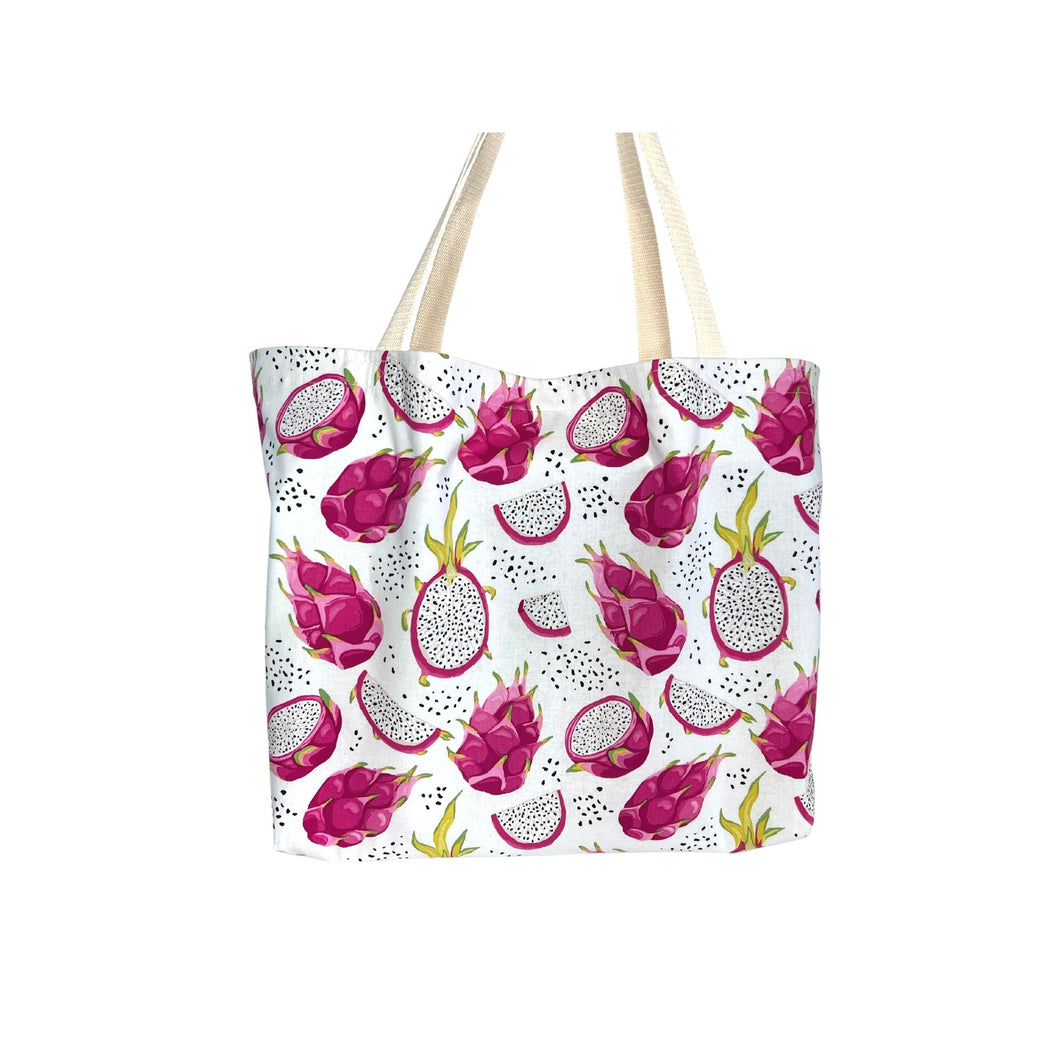Large cotton tote bag with a colorful print of whole, halved, and quartered dragon fruits, perfect for carrying groceries, books, and everyday essentials.