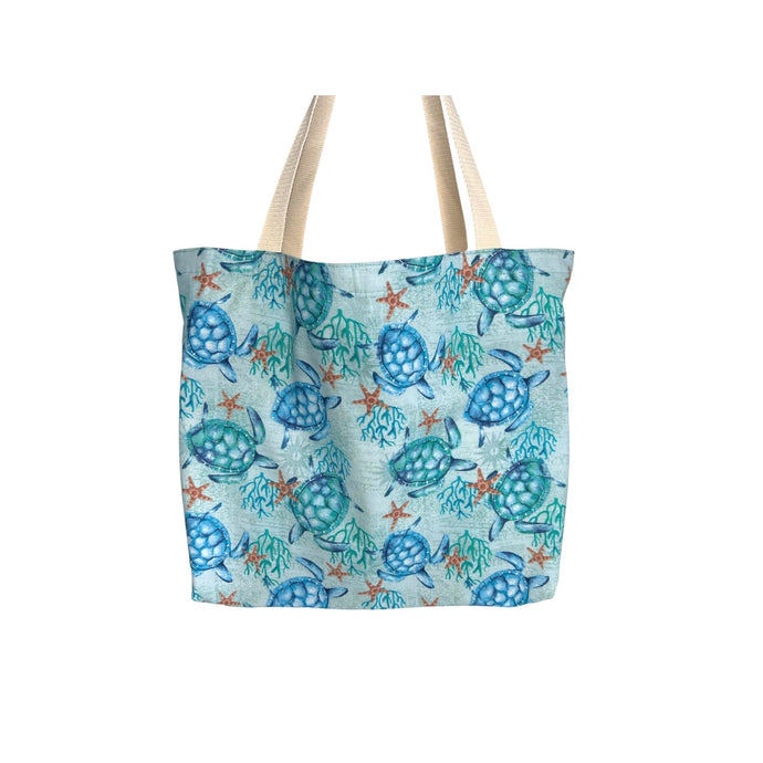 A cotton tote with a seafoam green background featuring honu (sea turtles), coral, and starfish designs. The tote is lined on the inside and has cotton webbing straps.