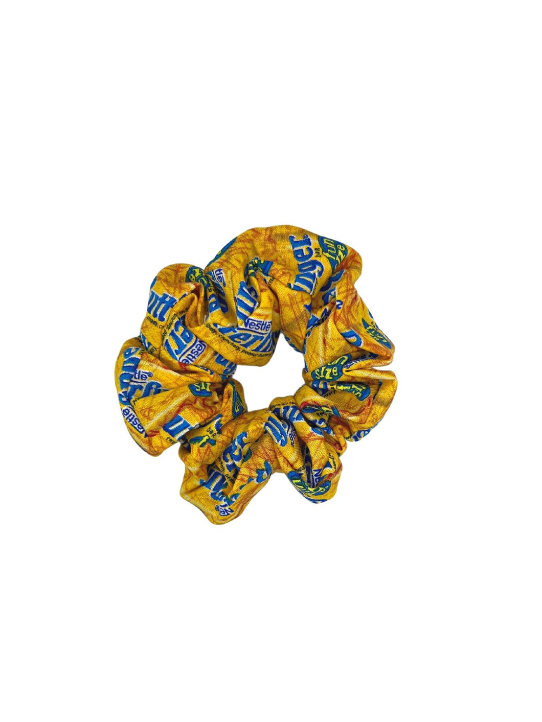 A scrunchie made with fabric featuring Butterfinger chocolate bars on a yellow gold background, made with cotton fabric.
