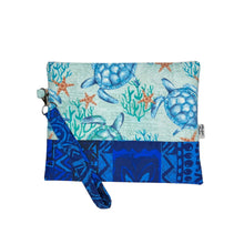 Load image into Gallery viewer, Cotton clutch with honu, coral and starfish on seafoam green backdrop on upper 2/3, and monochrome blue Hawaiian design on lower 1/3. Features a wristlet in the blue Hawaiian design and is lined on the inside.
